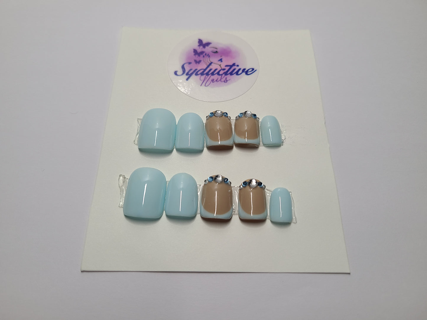 Pale blue French nails with gems on the middle and ring fingers. Short Square, (14 pieces) Press-On Nails including Prep Kit (PN000045)