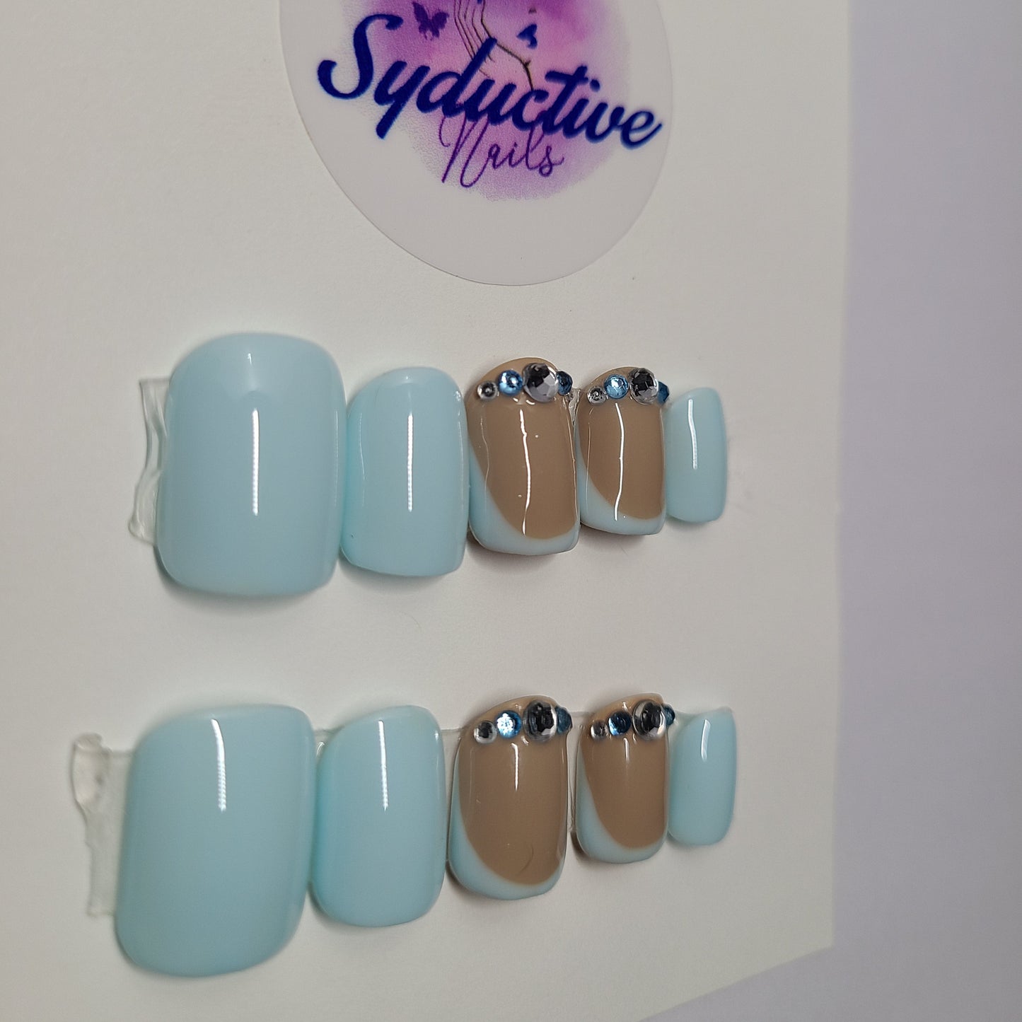 Pale blue French nails with gems on the middle and ring fingers. Short Square, (14 pieces) Press-On Nails including Prep Kit (PN000045)