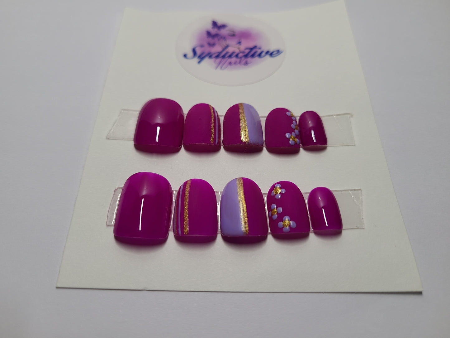 Dark and light purple matte and shiny nails. Accentuated with flowers and gold lines. Short Square, (14 pieces) Press-On Nails including Prep Kit (PN000047)