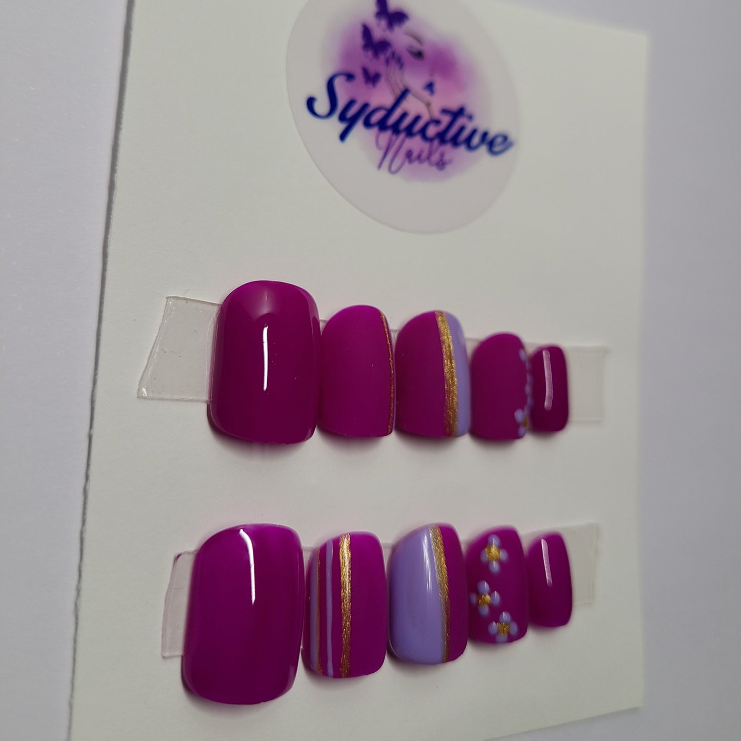 Dark and light purple matte and shiny nails. Accentuated with flowers and gold lines. Short Square, (14 pieces) Press-On Nails including Prep Kit (PN000047)